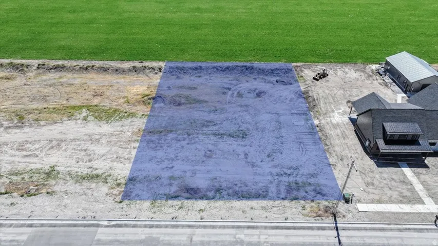 Expansive vacant lot featuring an undeveloped surface and direct street frontage