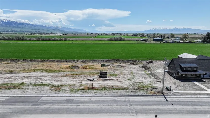 Expansive cleared lot offering significant development potential, with a paved road fronting the property