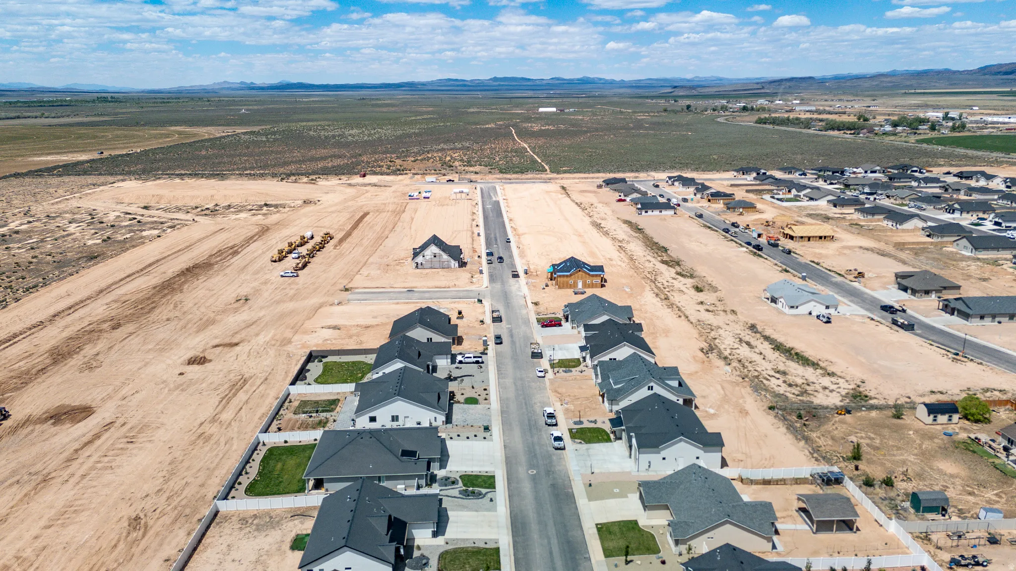 Developing residential area featuring single-story homes with dark shingle roofs