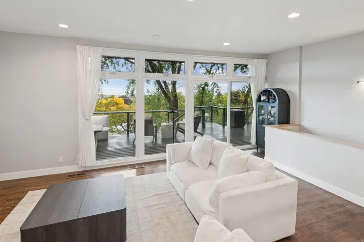 Spacious living area featuring expansive glass doors opening to an outdoor deck