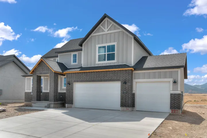 Contemporary exterior featuring brick veneer, vertical siding, and a gabled roof