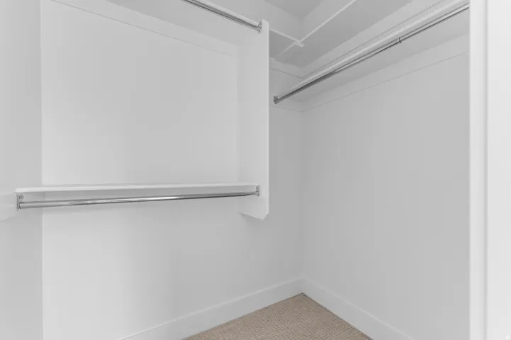 Recessed closet with integrated shelving and chrome hanging rods