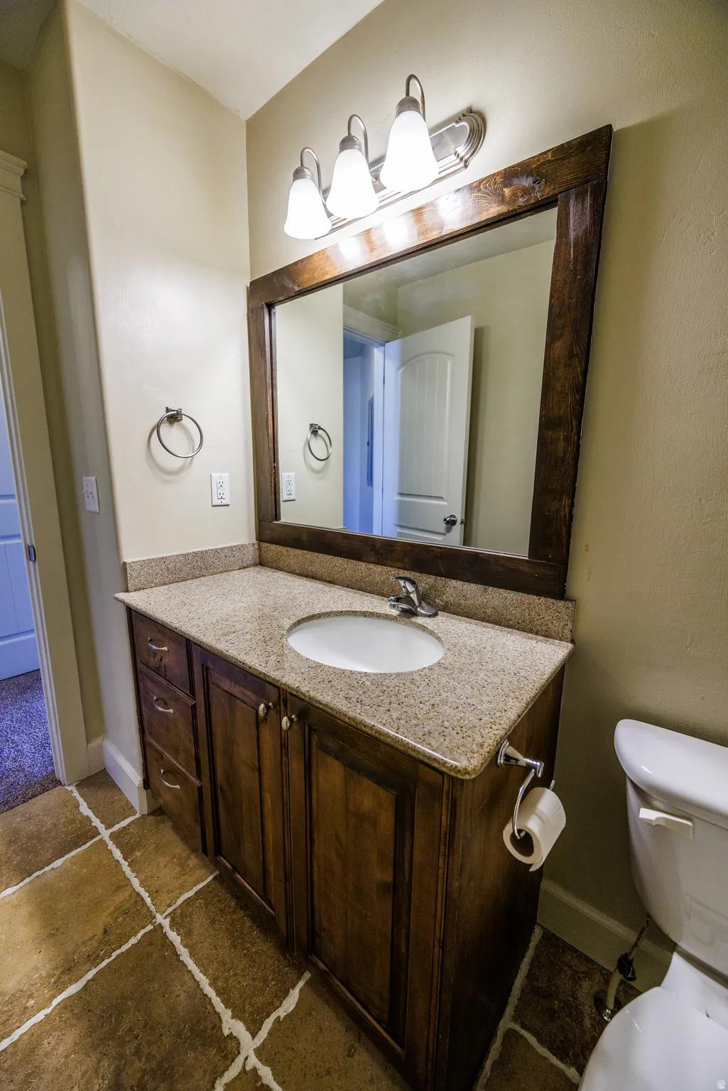 Bathroom vanity with a granite countertop and an undermount sink