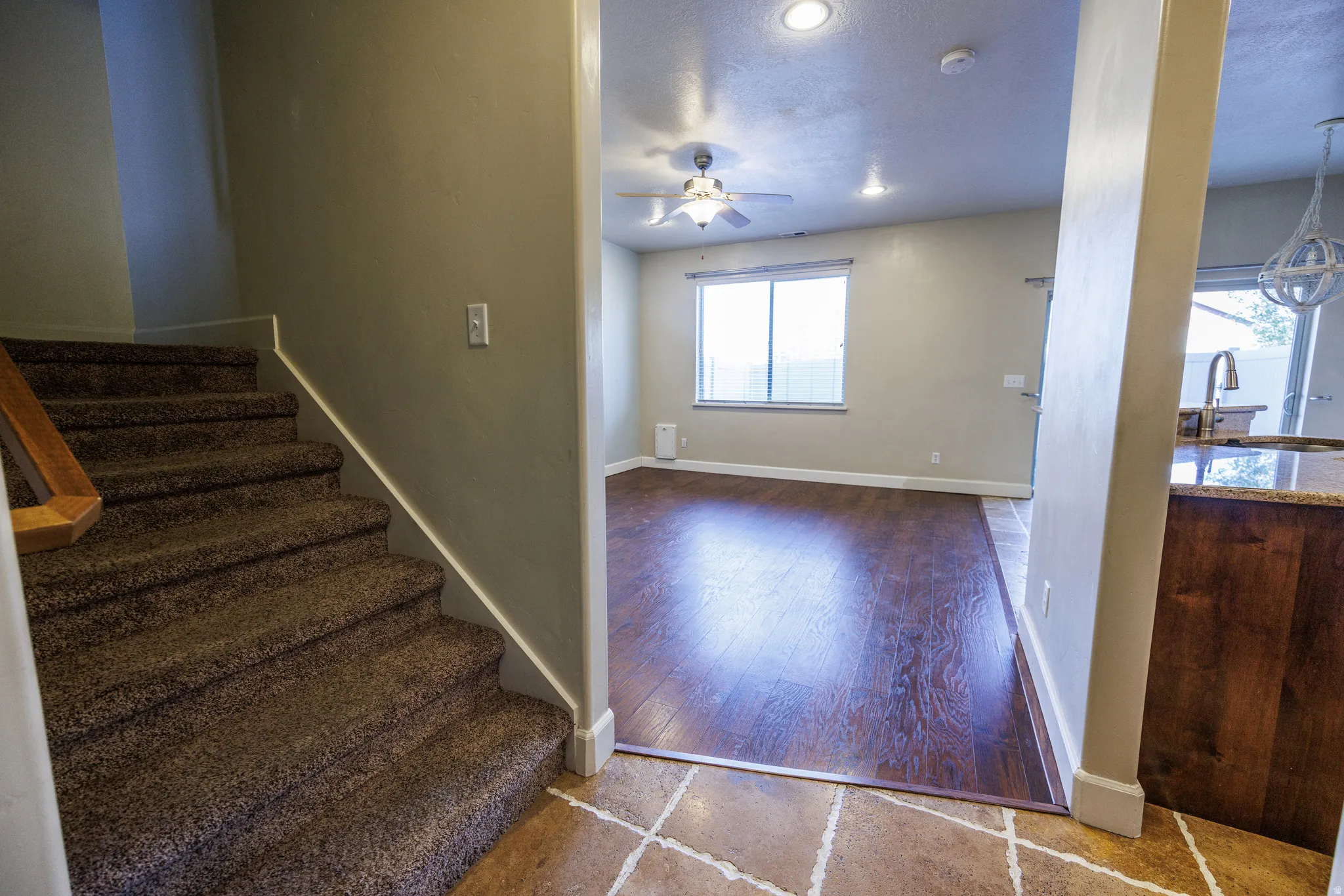 Open concept living area with wood-finish flooring, recessed lighting, and a ceiling fan
