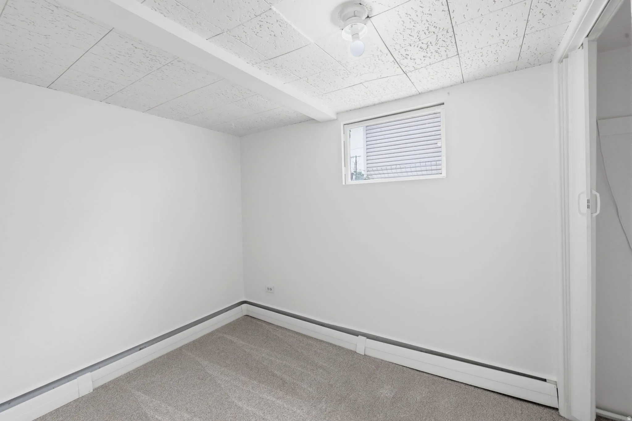 Neutral white walls throughout, complemented by gray carpeting