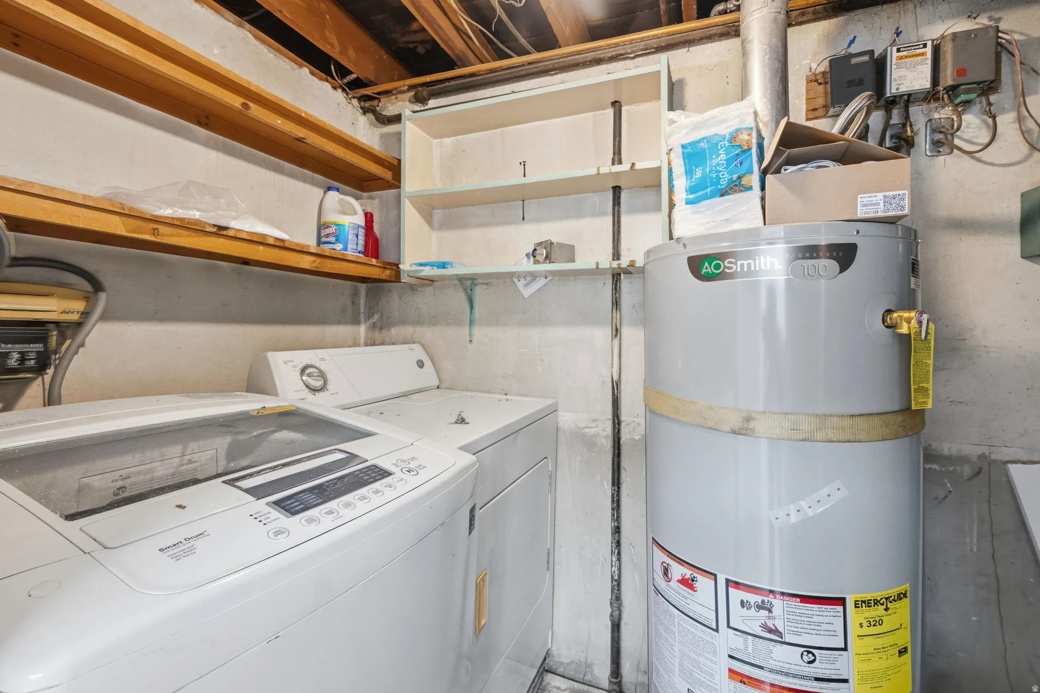 Dedicated laundry area featuring a top-load washing machine and front-load dryer