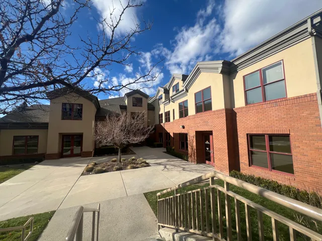 Multi-story building exterior featuring a combination of brick and stucco finishes
