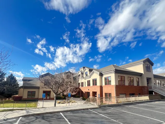 Multi-story commercial building featuring a stucco and brick exterior