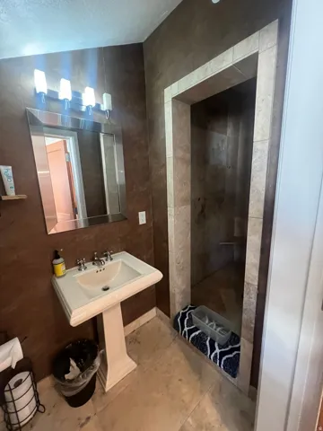 Recessed shower with tiled walls and a built-in shower bench