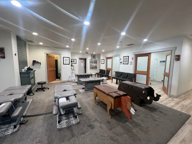 Spacious interior featuring recessed lighting, a neutral color palette, wood-finish flooring, and multiple doorways with frosted glass panels