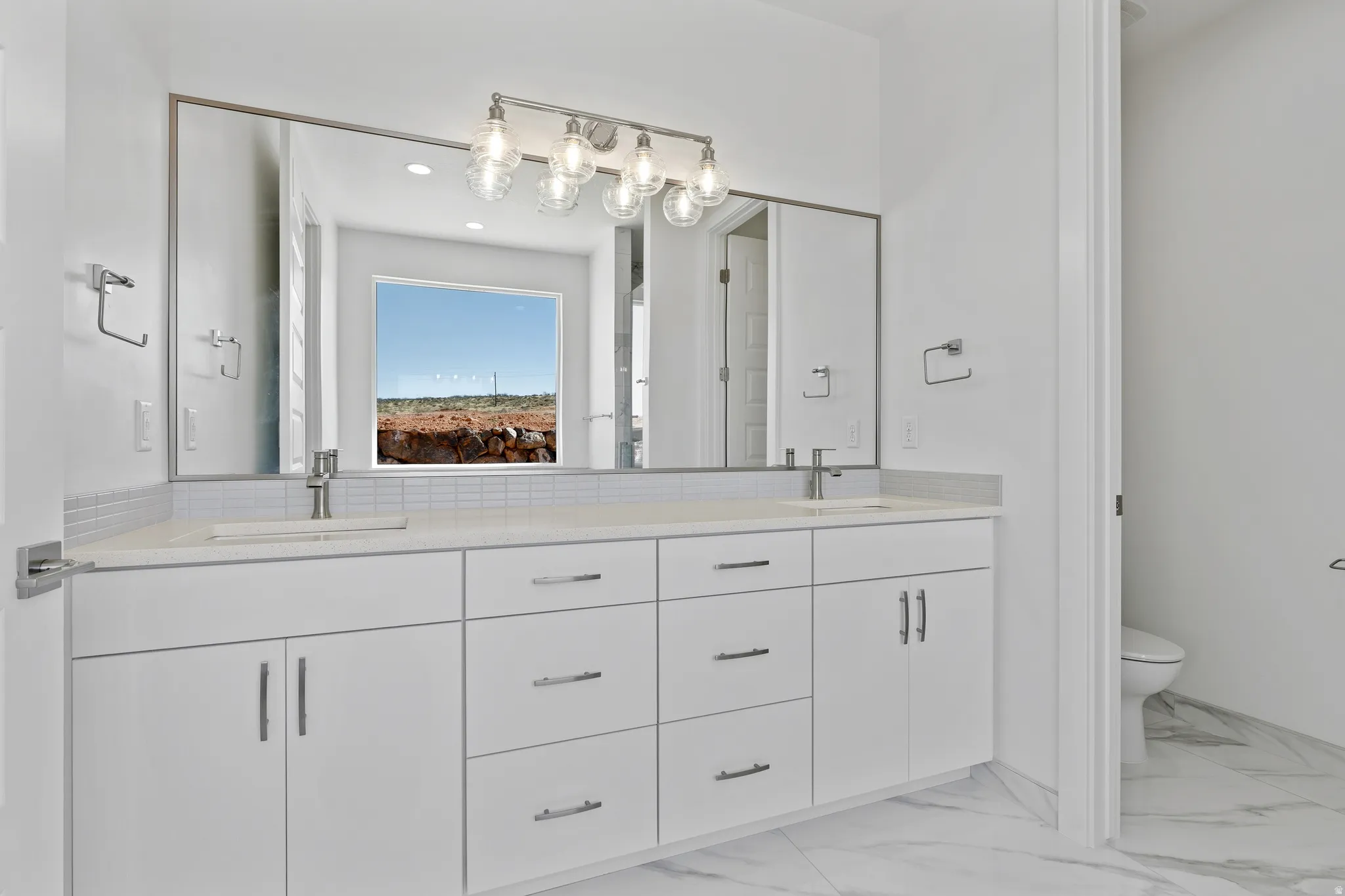Double vanity with dual undermount sinks and chrome fixtures