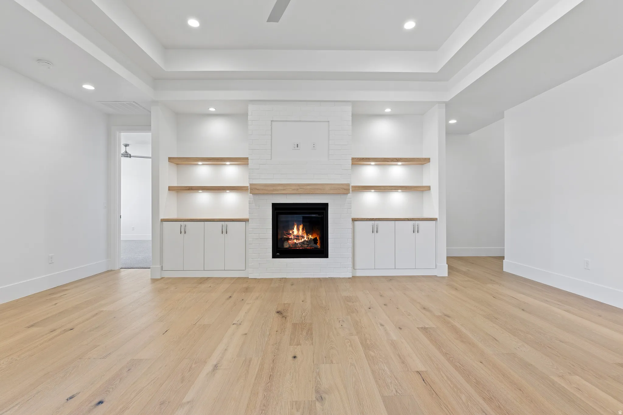 Integrated fireplace with brick-finish surround and a wood mantel