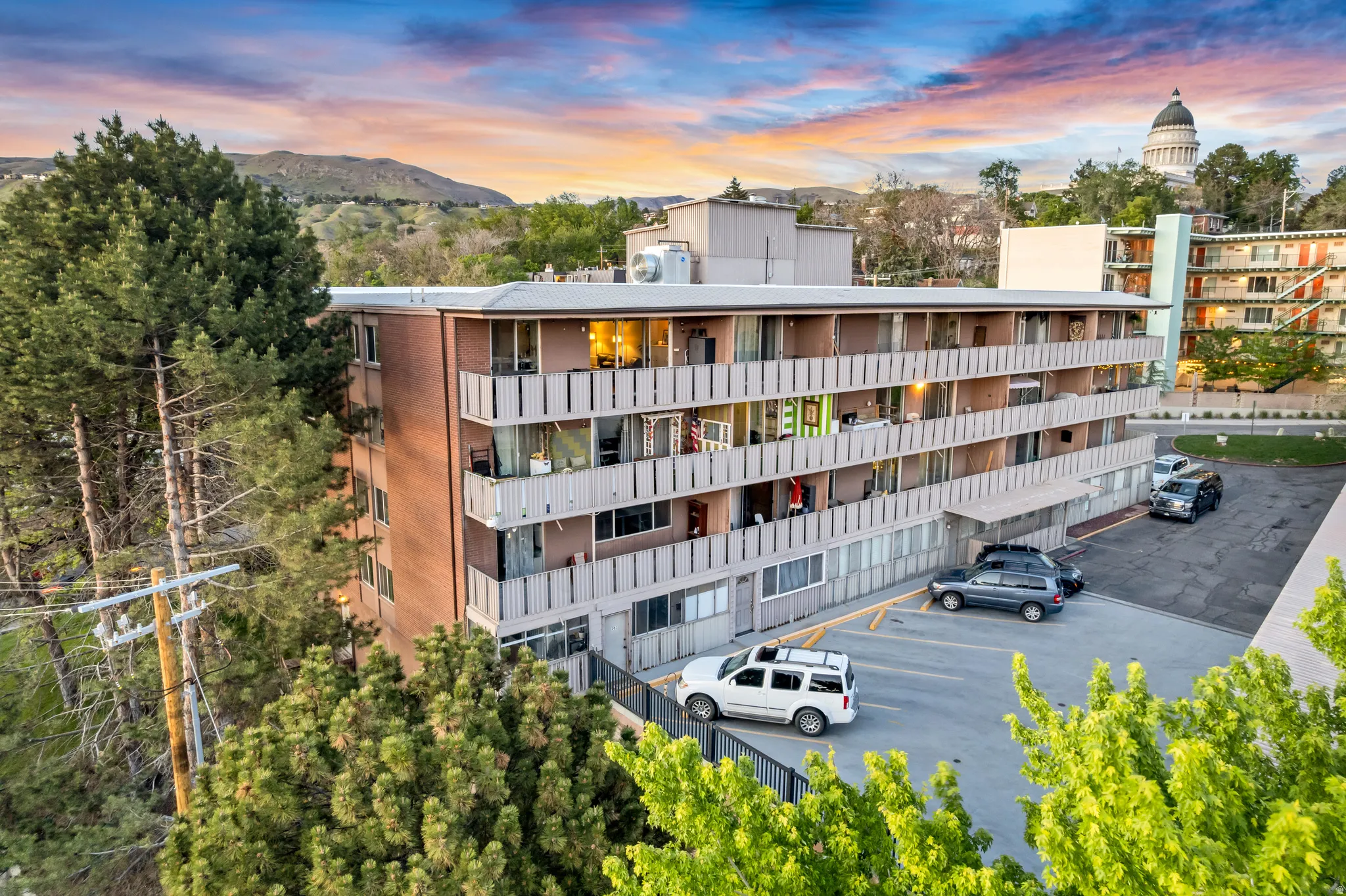 Multi-story building featuring brick and panel facades with individual balconies