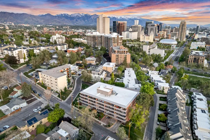 Cityscape featuring a dense urban environment with a variety of architectural styles, including modern high-rises and residential buildings