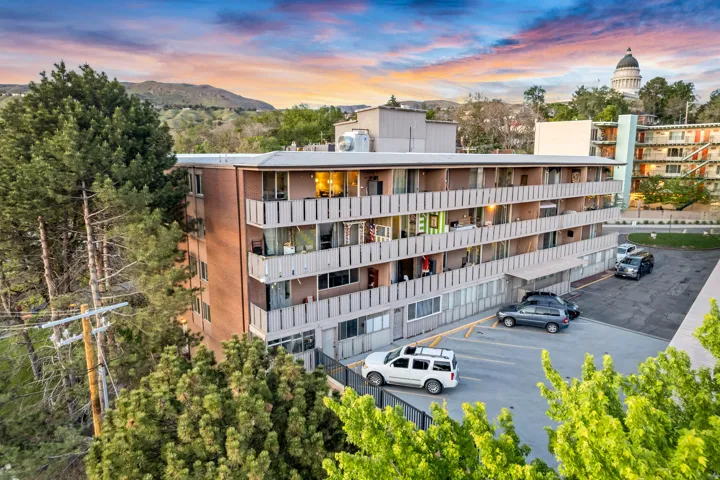 Multi-story building featuring brick and panel facades with individual balconies