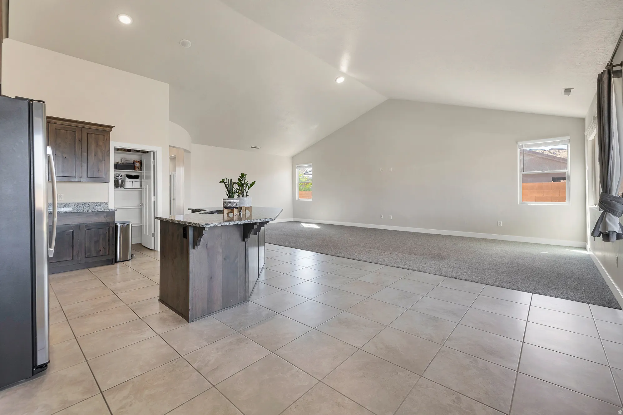 Open-concept interior featuring a vaulted ceiling and recessed lighting