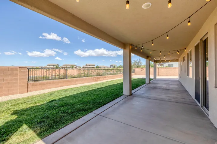 Covered patio featuring a concrete surface, overhead lighting, and multiple support columns