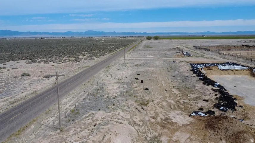 Expansive rural property featuring an unpaved road and cleared land