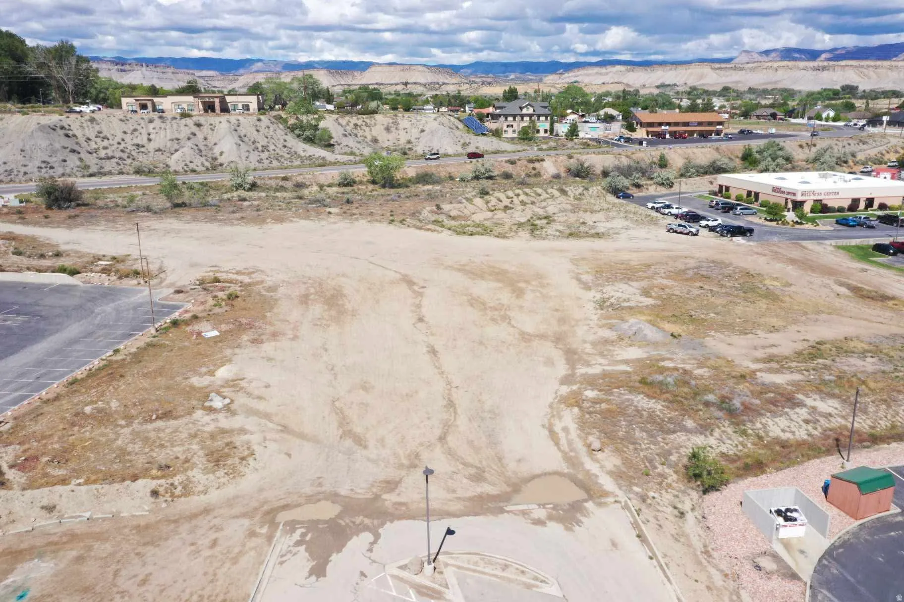 Expansive undeveloped lot with partial asphalt paving and a flat topography