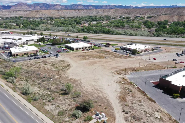 Expansive undeveloped land parcel featuring direct road frontage and mountain backdrop