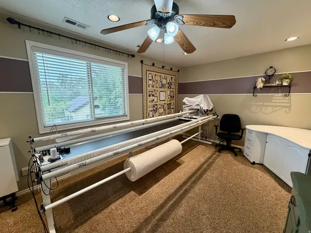 Room featuring a ceiling fan with integrated lighting, recessed lighting, and a large window with blinds