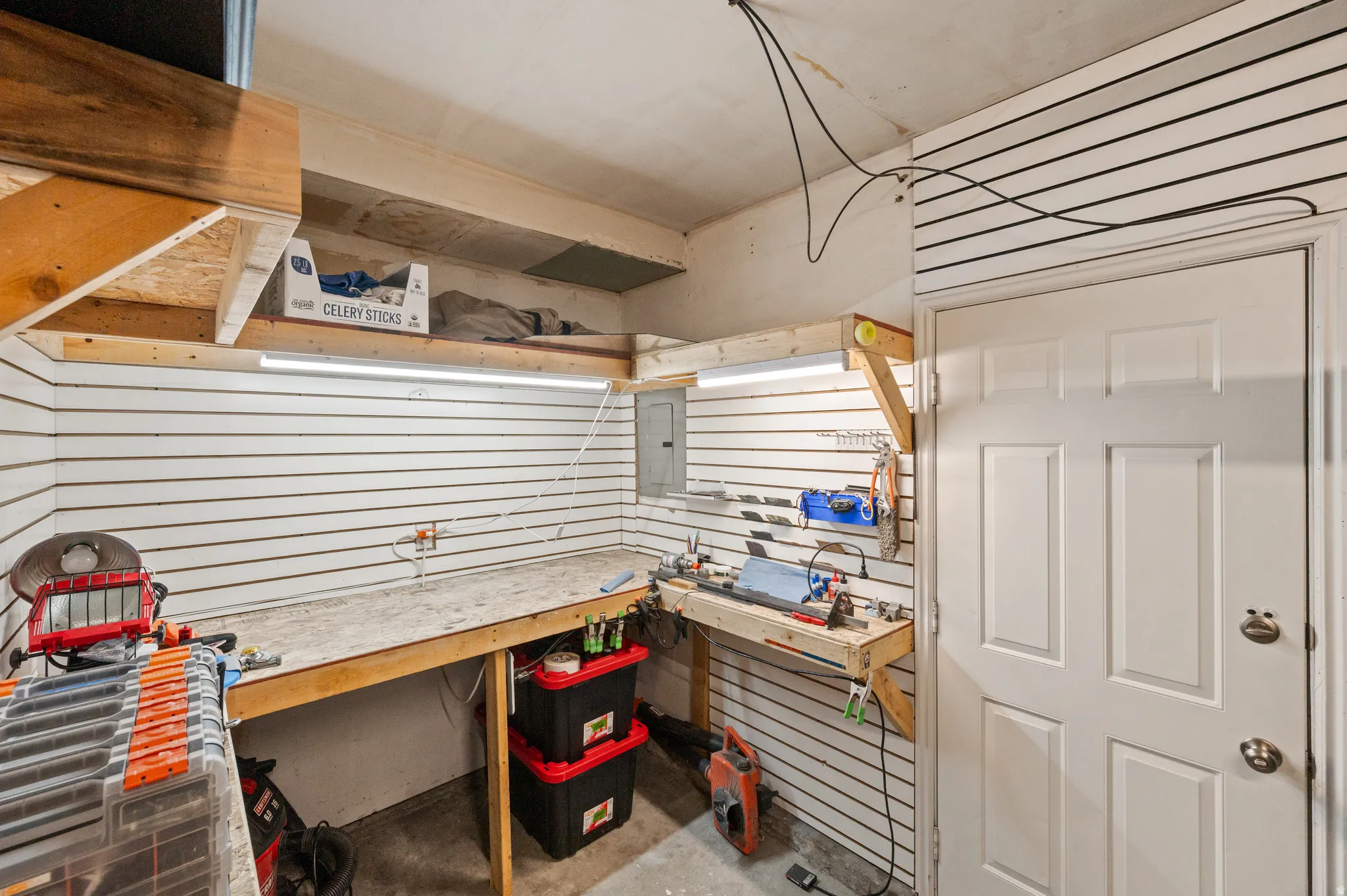 Featuring slat walls, and a workbench.