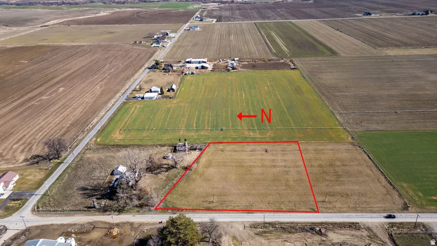Expansive land parcel outlined in red, featuring a flat, cleared terrain