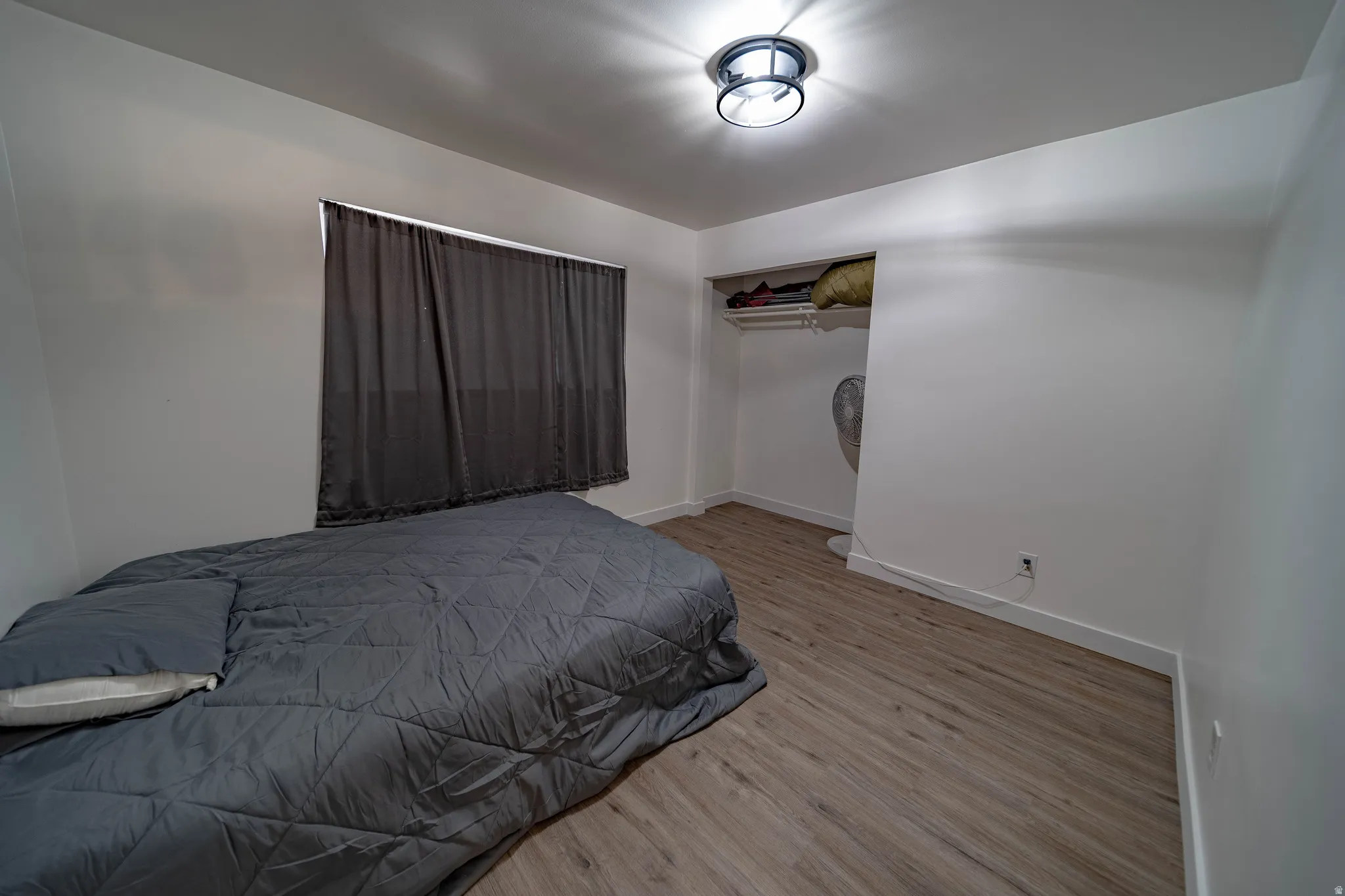 Room featuring light wood-finish flooring and a flush-mount ceiling light fixture