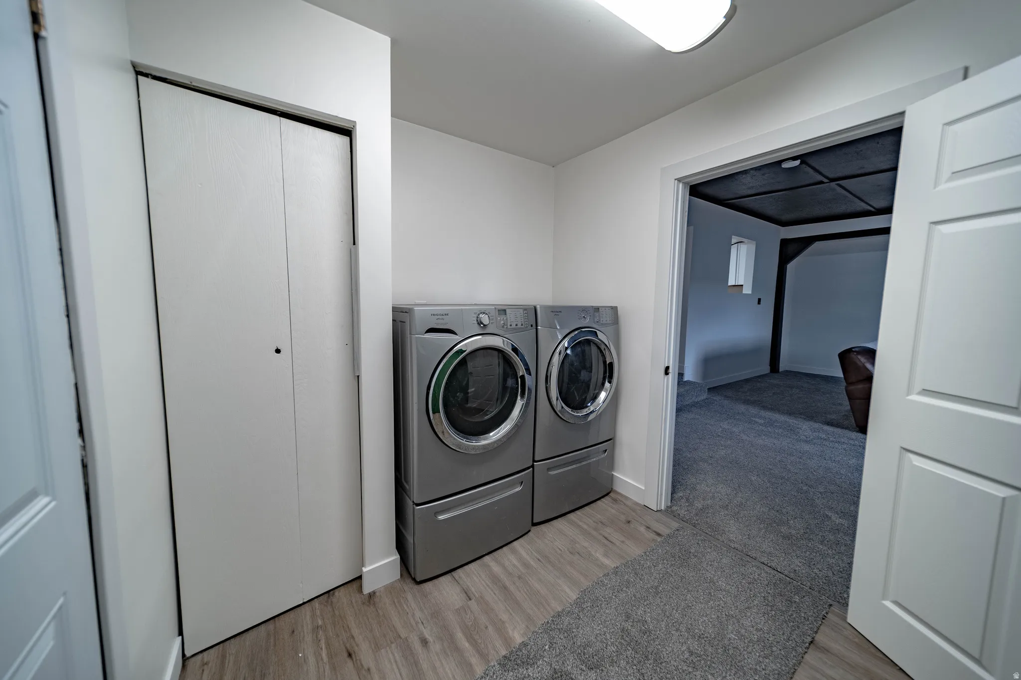 Dedicated laundry area with wood-finish flooring