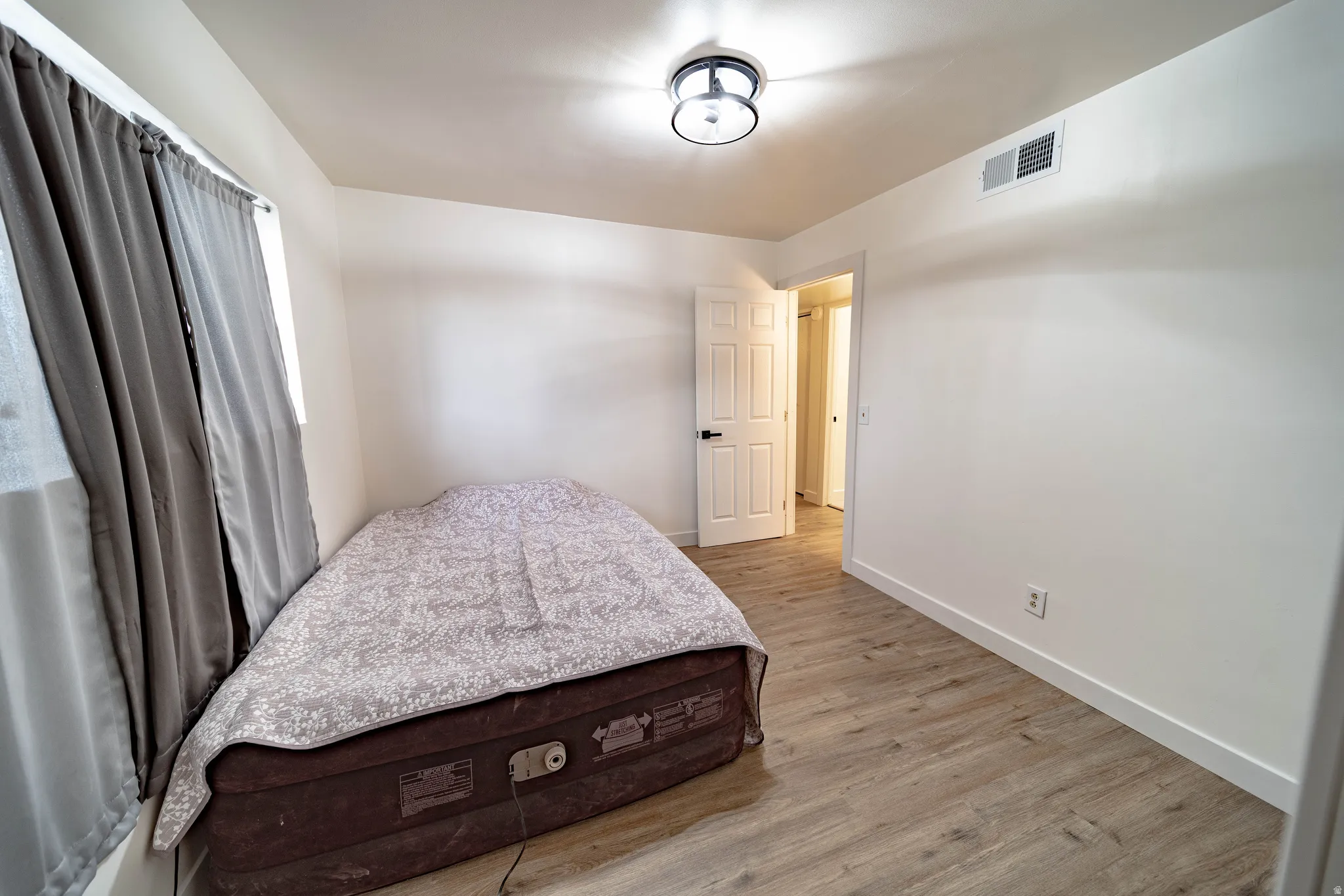 Light wood-finish flooring complements the neutral wall tones
