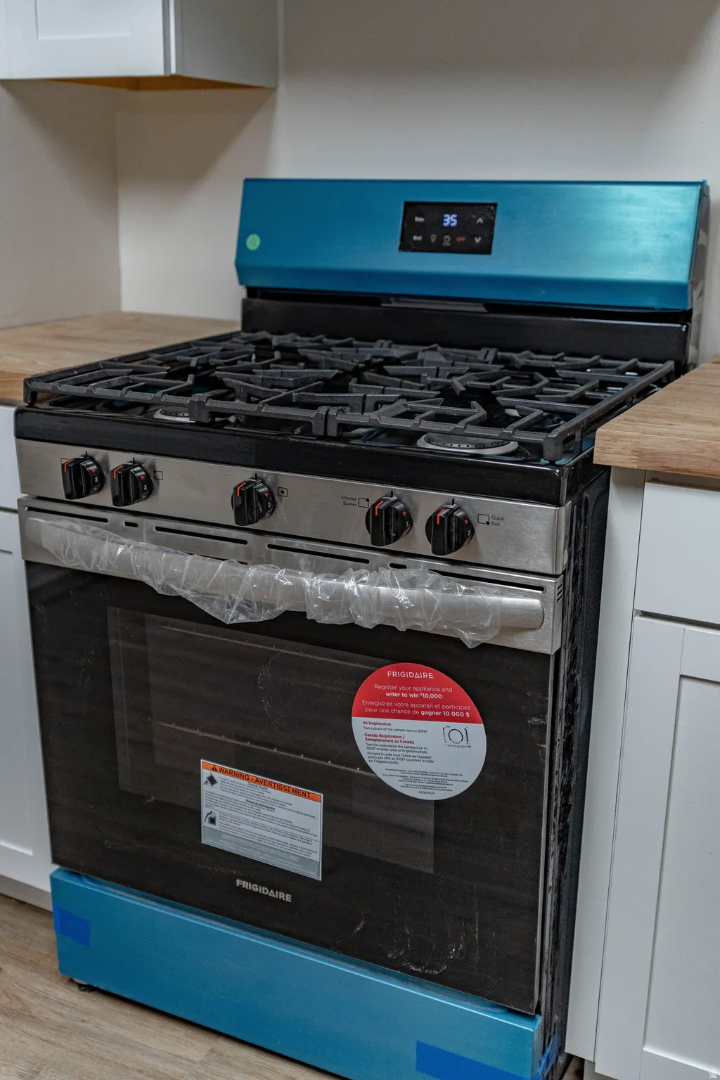 Stainless steel range with gas cooktop, digital display, and a full-size oven