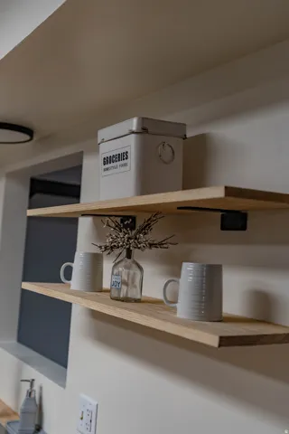 Contemporary open shelving featuring wood-finish surfaces and dark-toned brackets