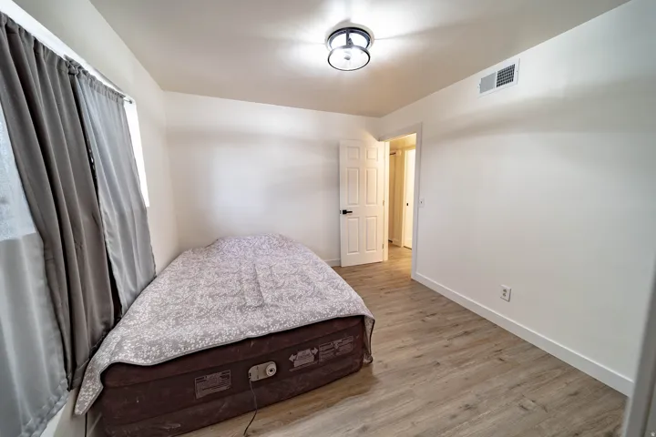 Light wood-finish flooring complements the neutral wall tones