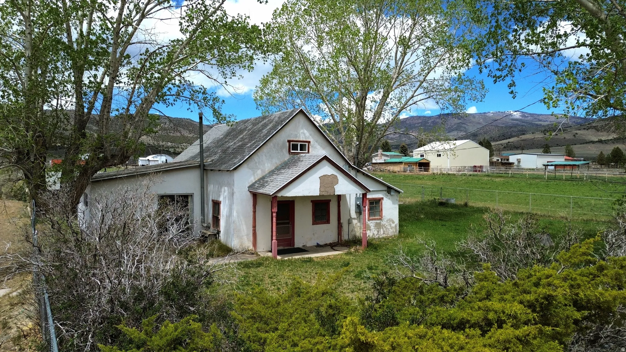 Two-story residence featuring a covered front porch and a gabled roof