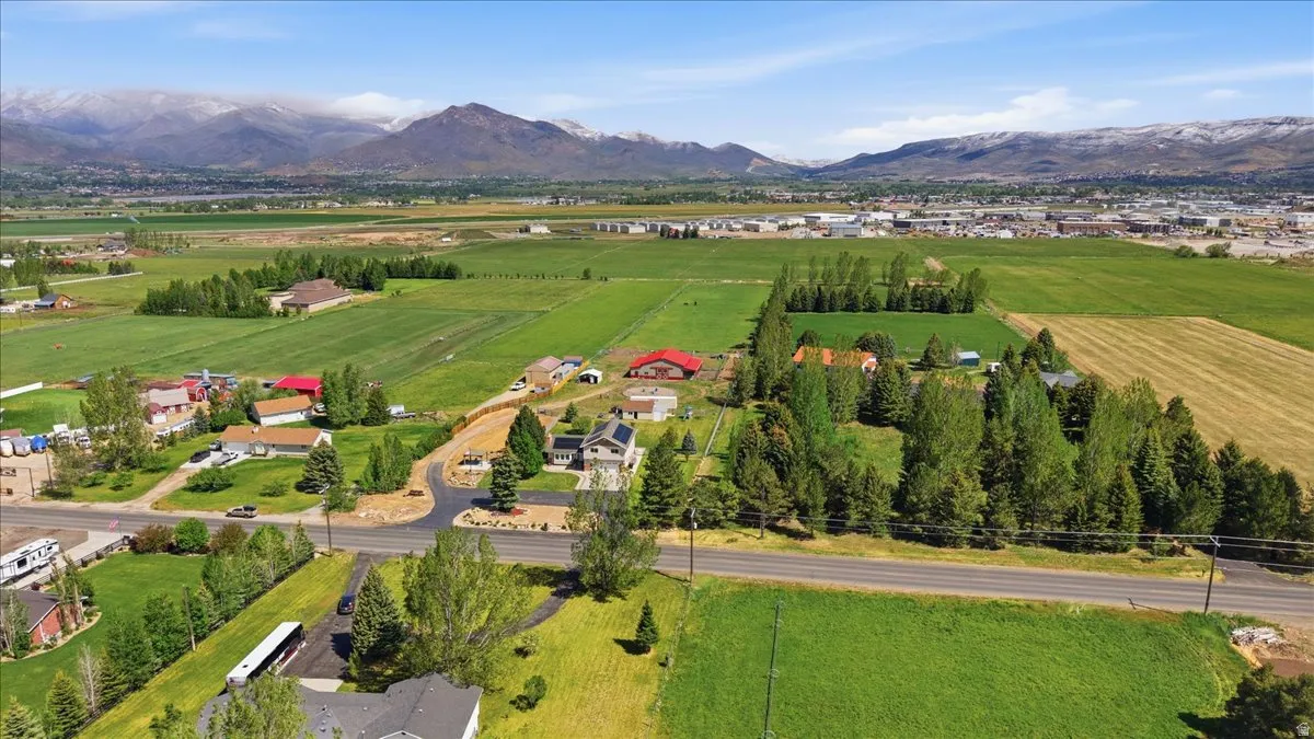 Expansive landscape featuring agricultural fields and residential properties