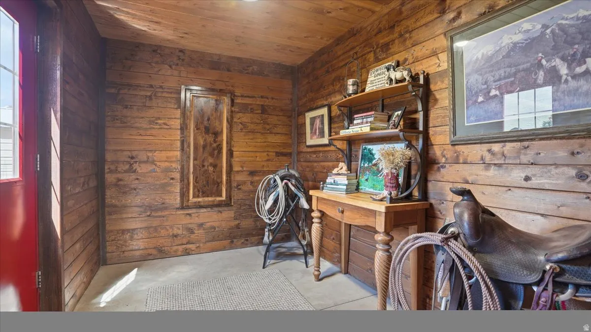 Wood-paneled interior featuring a red entry door with window, overhead lighting, and an inset wood-paneled feature