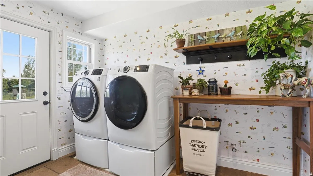 Utility room featuring a white paneled door with glass inserts, a double-hung window, and a wood-finish countertop