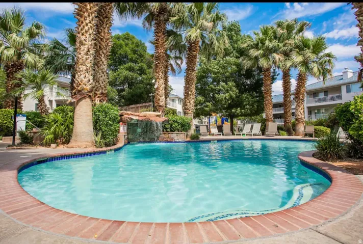 Resort-style swimming pool with brick coping and a decorative tiled edge