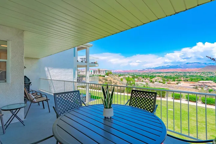 Expansive covered balcony featuring a metal railing, durable flooring, and ample space for outdoor furnishings