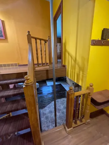 Wood-finish stairway with carved balusters and newel posts