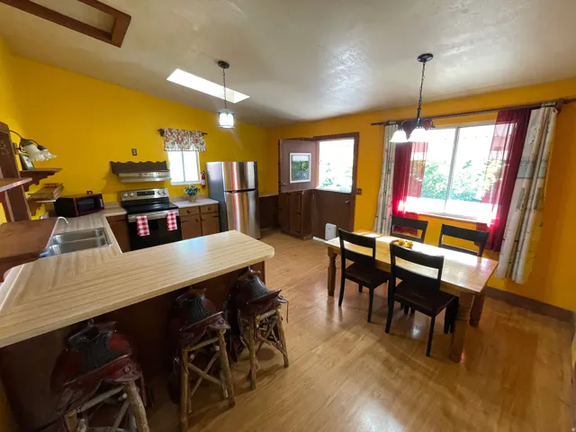 Spacious kitchen and dining area with wood-finish flooring