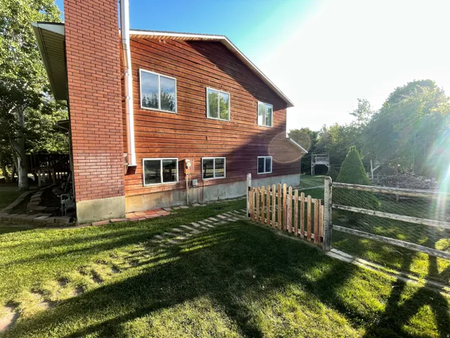Two-story exterior with wood siding and a brick chimney