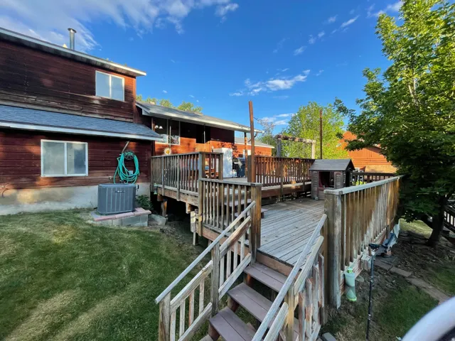 Multi-level wood deck with wood railings, providing extensive outdoor living space