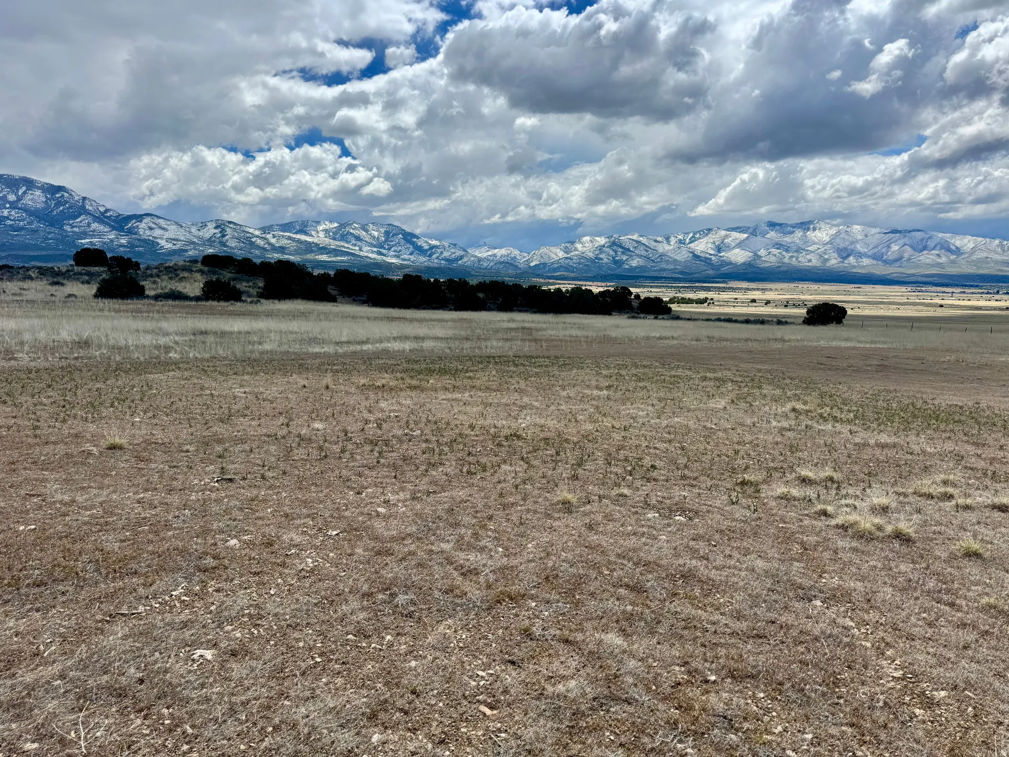 Expansive open land with a distant mountain range featuring snow-capped peaks, 19.5 acres north of Fillmore, UT