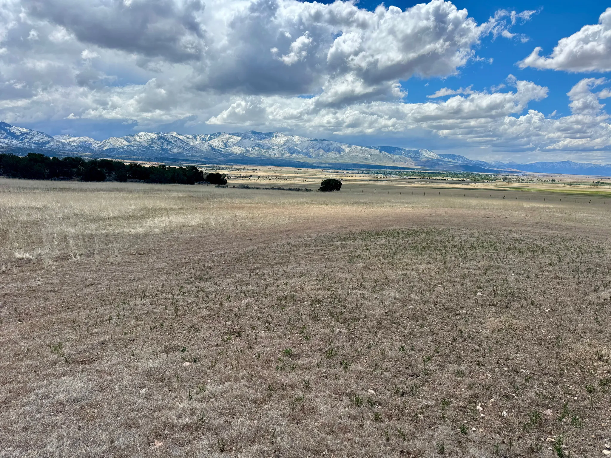 Expansive open land with a distant mountain range featuring snow-capped peaks, 19.5 acres north of Fillmore, UT