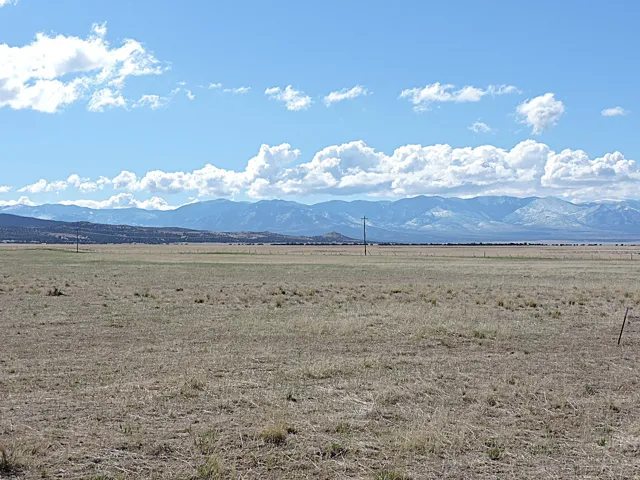 Expansive open land with a distant mountain range backdrop
