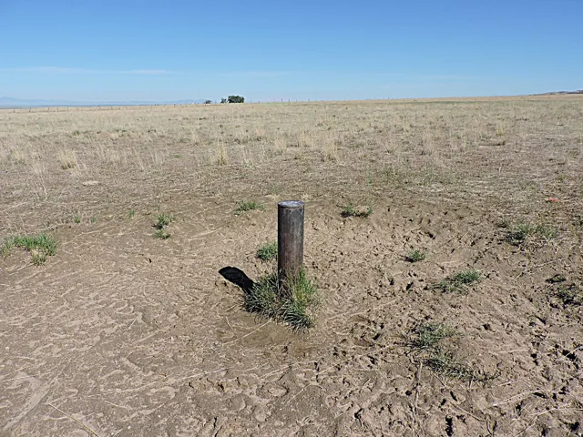 Expansive undeveloped land featuring a clear horizon and distant mountain range
