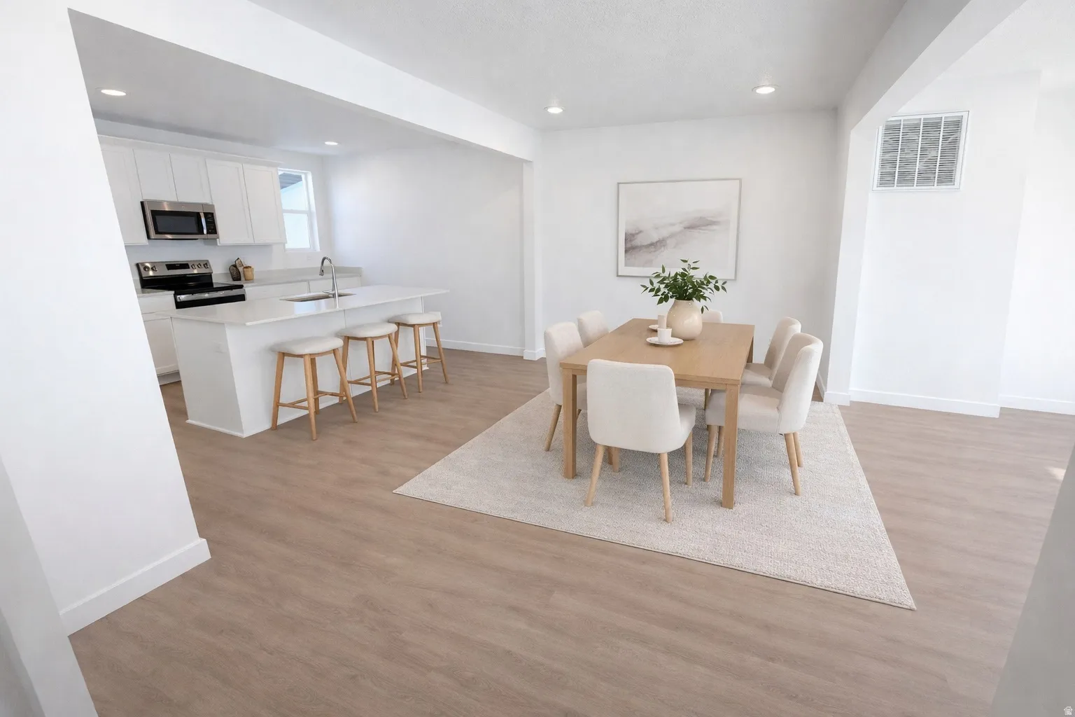 Open-concept living space with light wood-finish flooring