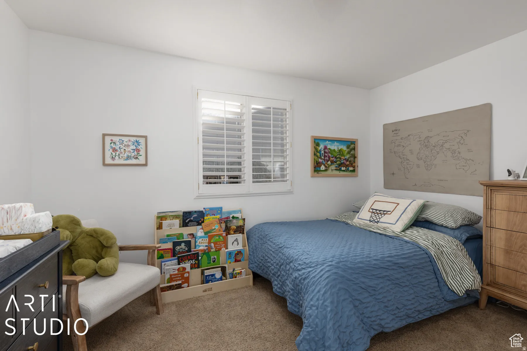 Crisp white walls with a window featuring white plantation shutters, complemented by neutral-toned carpeting