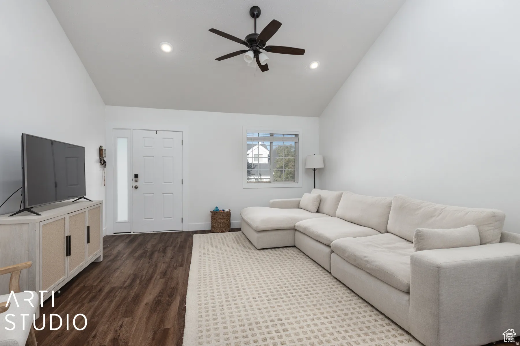 Vaulted ceilings featuring recessed lighting and a ceiling fan, wood-finish flooring, and white walls